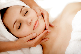 a woman getting a facial treatment